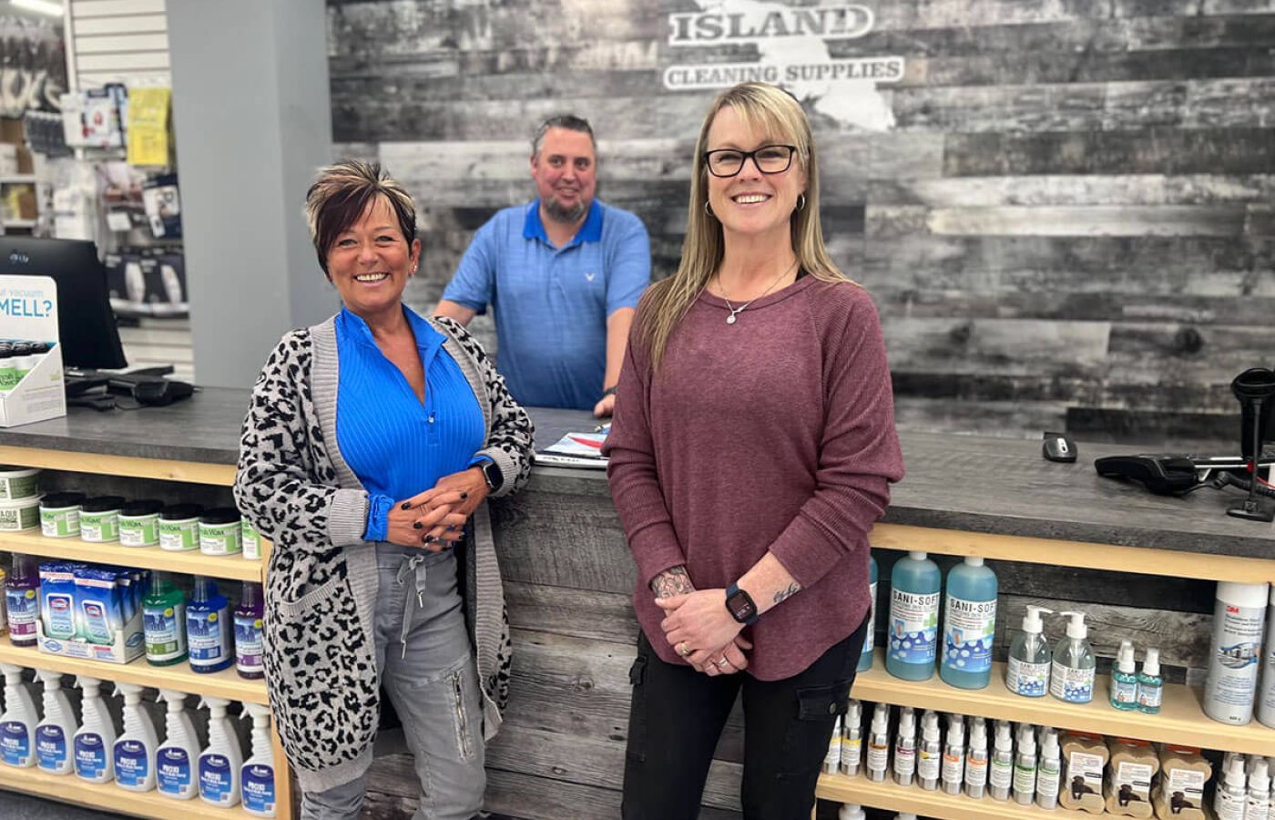 Staff of Island Cleaning Supplies standing in front of counter, smiling