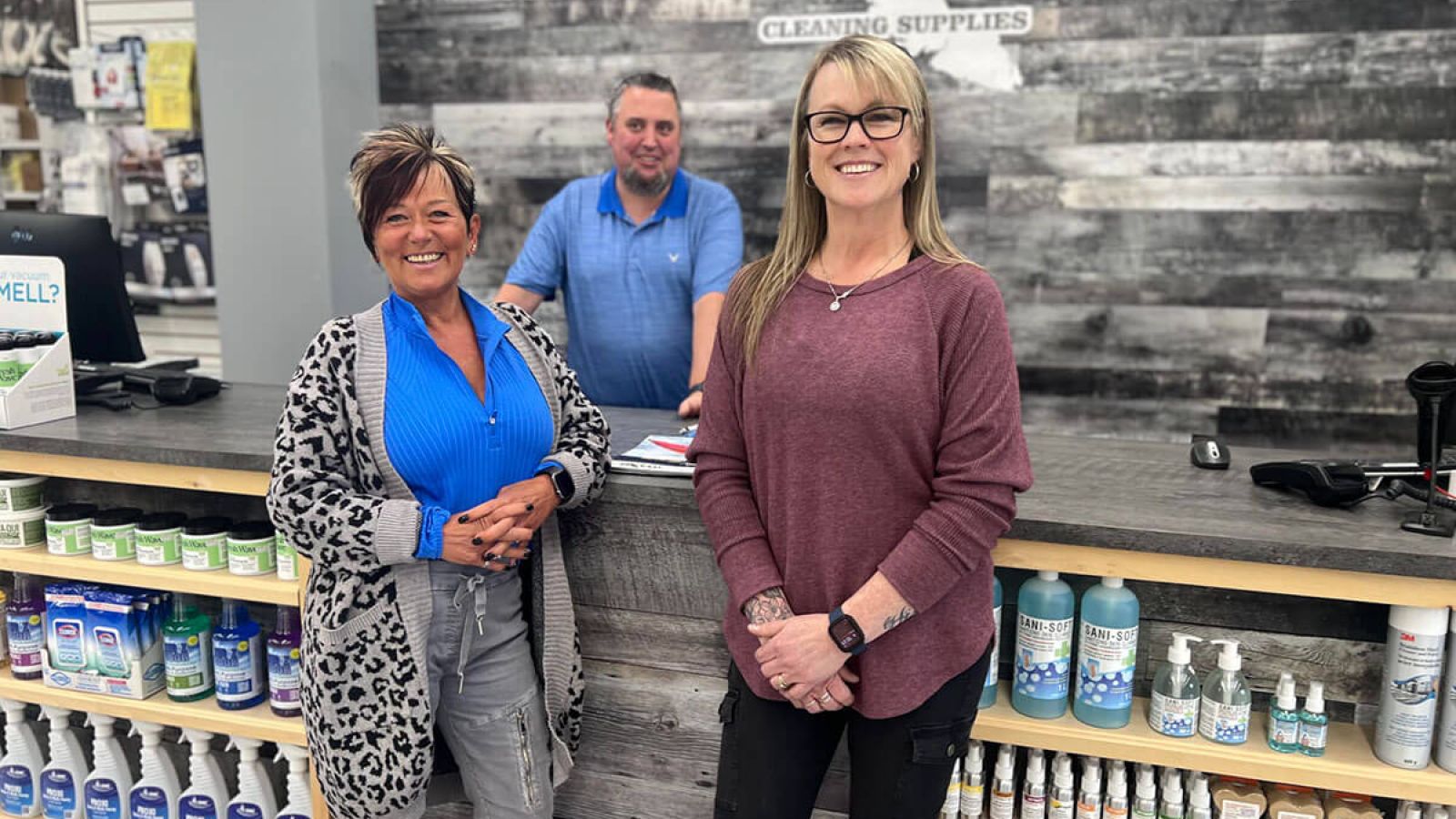 Staff of Island Cleaning Supplies standing in front of counter, smiling